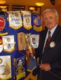 The picture says it all...  Woodland Rotarian Jim Nolan, points to the Club banner from his town of origin (Galway, Ireland), holding a bottle of the national libation (Irish whisky).